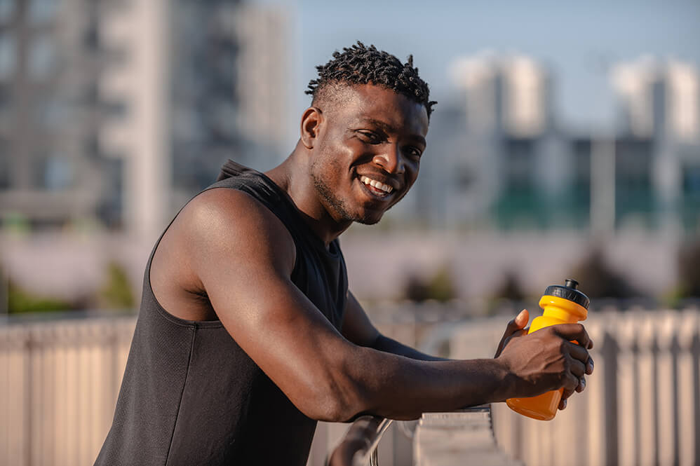 happy-african-man-in-sportswear-holding-water-bott-2026-01-08-02-40-46-utc (1)